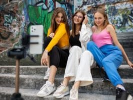 A group of young individuals dressed in trendy streetwear outfits, showcasing the vibrant evolution of street fashion in an urban environment.